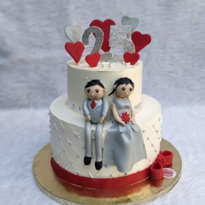 Sitting Couple Figure Two Tier Cake by Bakeology, Gwalior